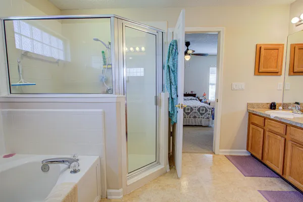 a bathroom with a tub a sink and mirrors