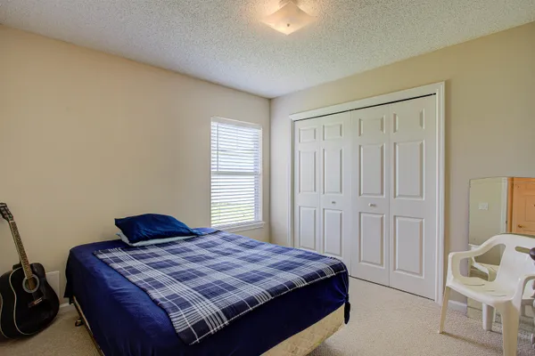 a bedroom with a bed and a window