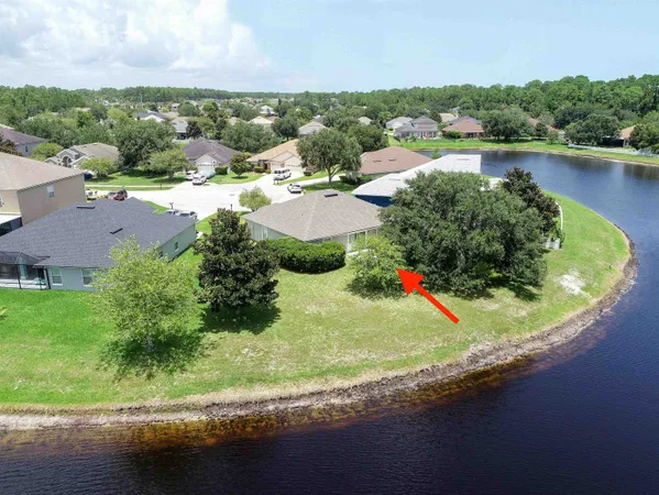 an aerial view of residential houses with outdoor space and river