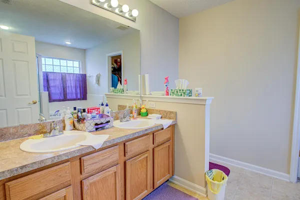a kitchen with a sink cabinets and wooden floor
