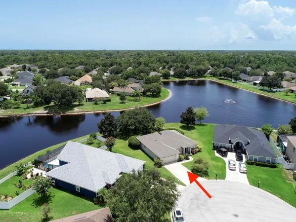 an aerial view of a house with a lake view