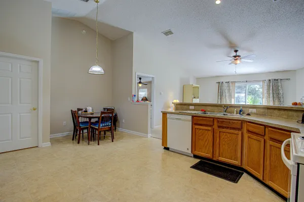 a large kitchen with dining table and chairs