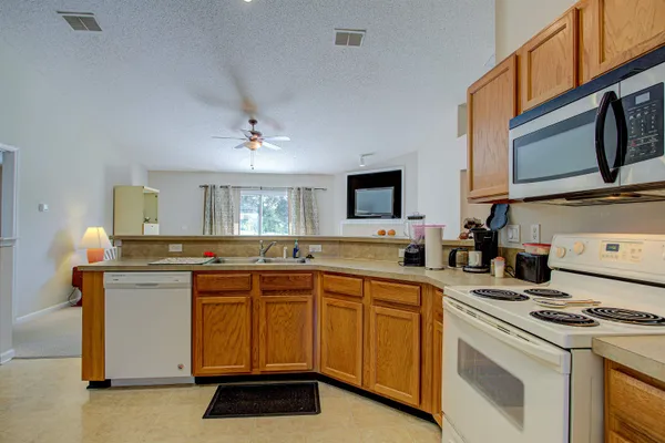 a kitchen with a sink stove and microwave