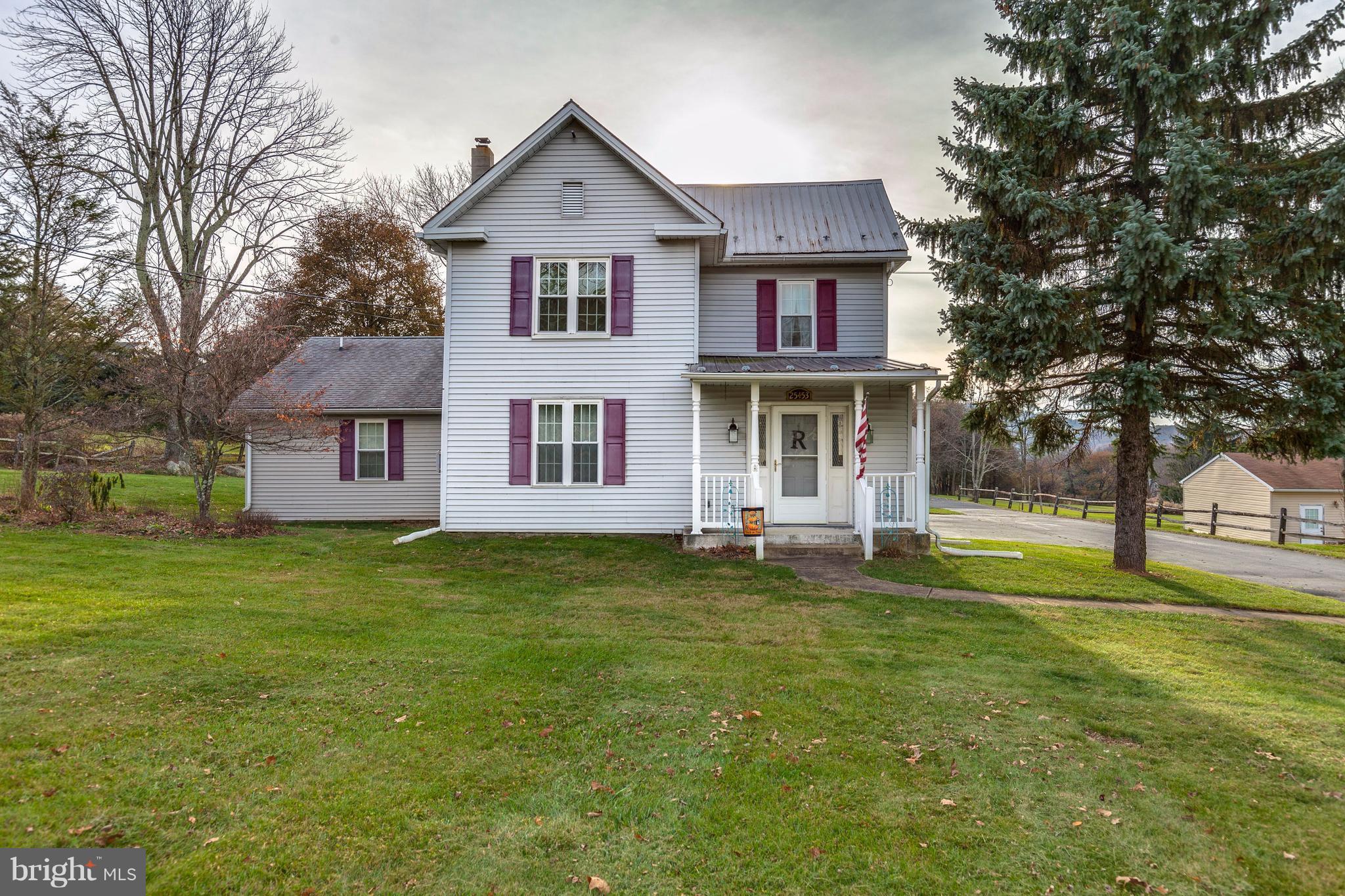 25453 Highfield Road Cascade, MD 21719 - Photo 1 of 30 a front view of a house with a garden