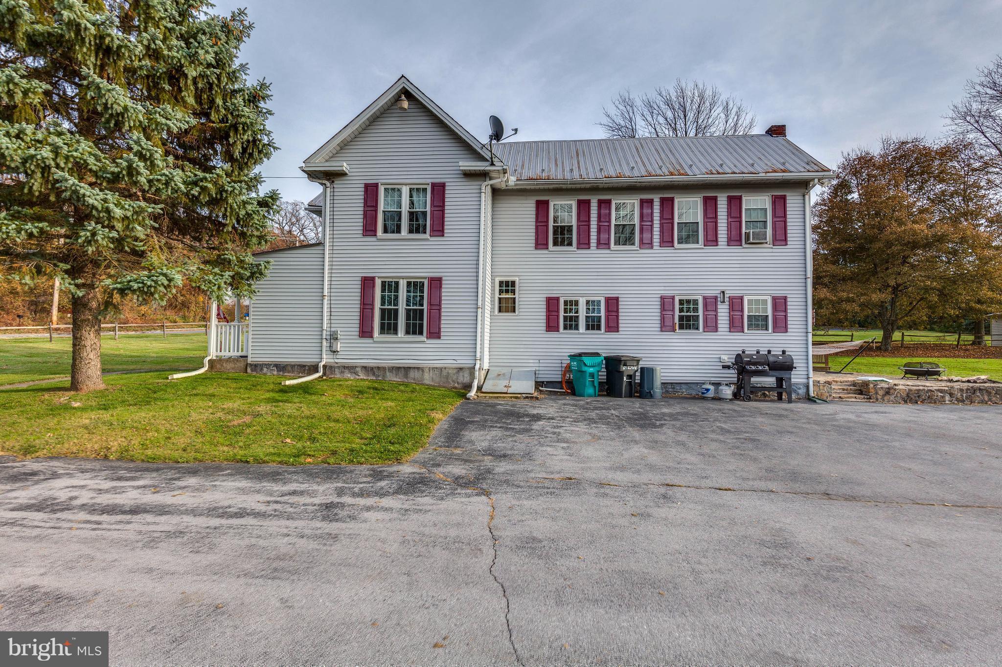 25453 Highfield Road Cascade, MD 21719 - Photo 2 of 30 a view of a house with a yard and large tree