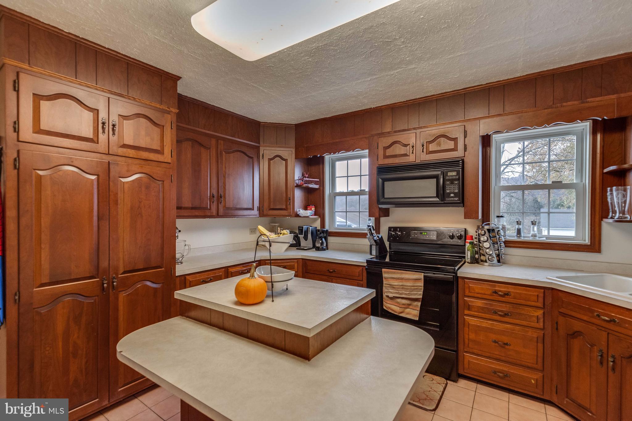 25453 Highfield Road Cascade, MD 21719 - Photo 14 of 30 a kitchen with stainless steel appliances granite countertop a sink stove and refrigerator