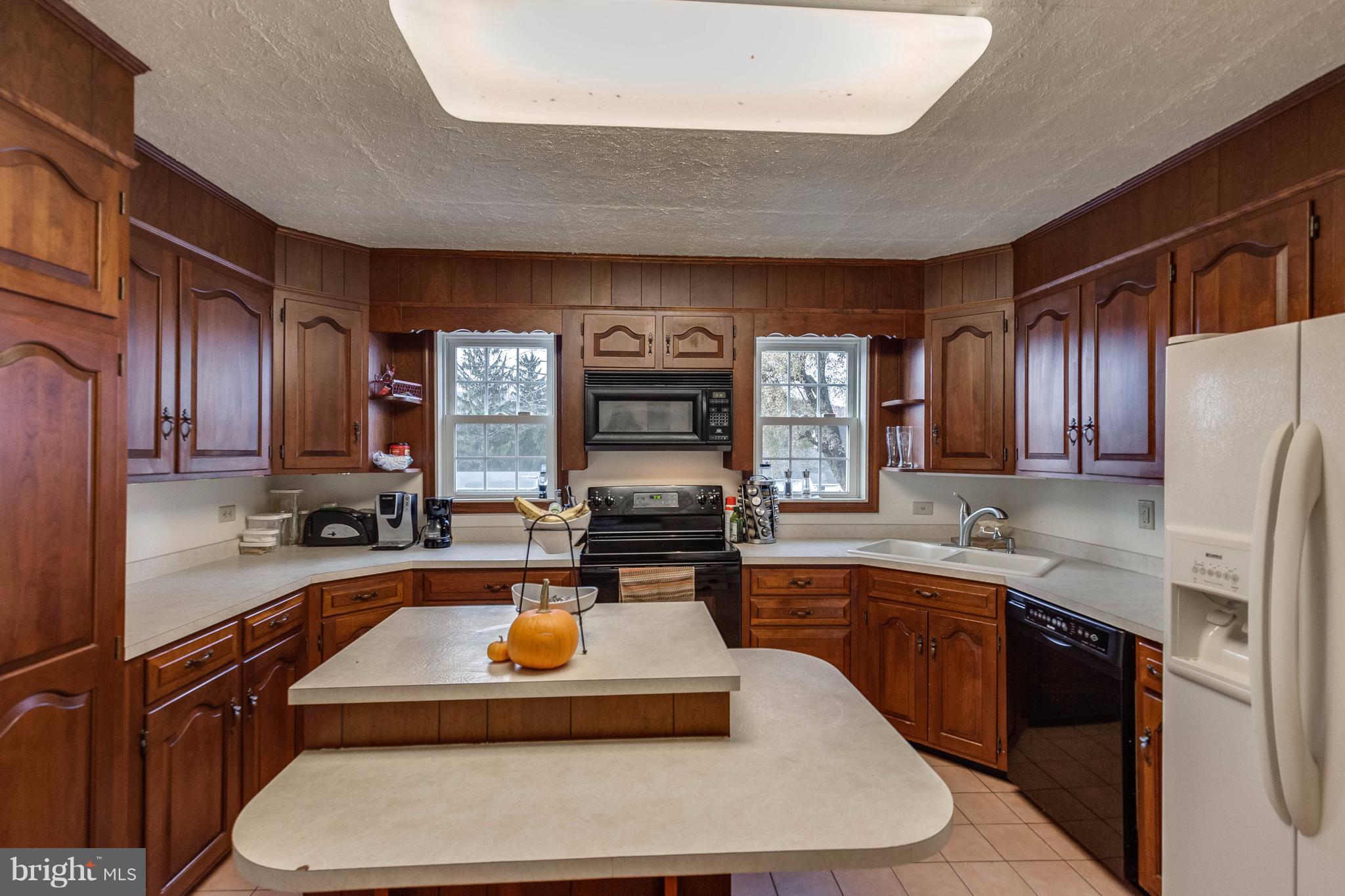 25453 Highfield Road Cascade, MD 21719 - Photo 15 of 30 a kitchen with stainless steel appliances granite countertop a sink refrigerator and cabinets