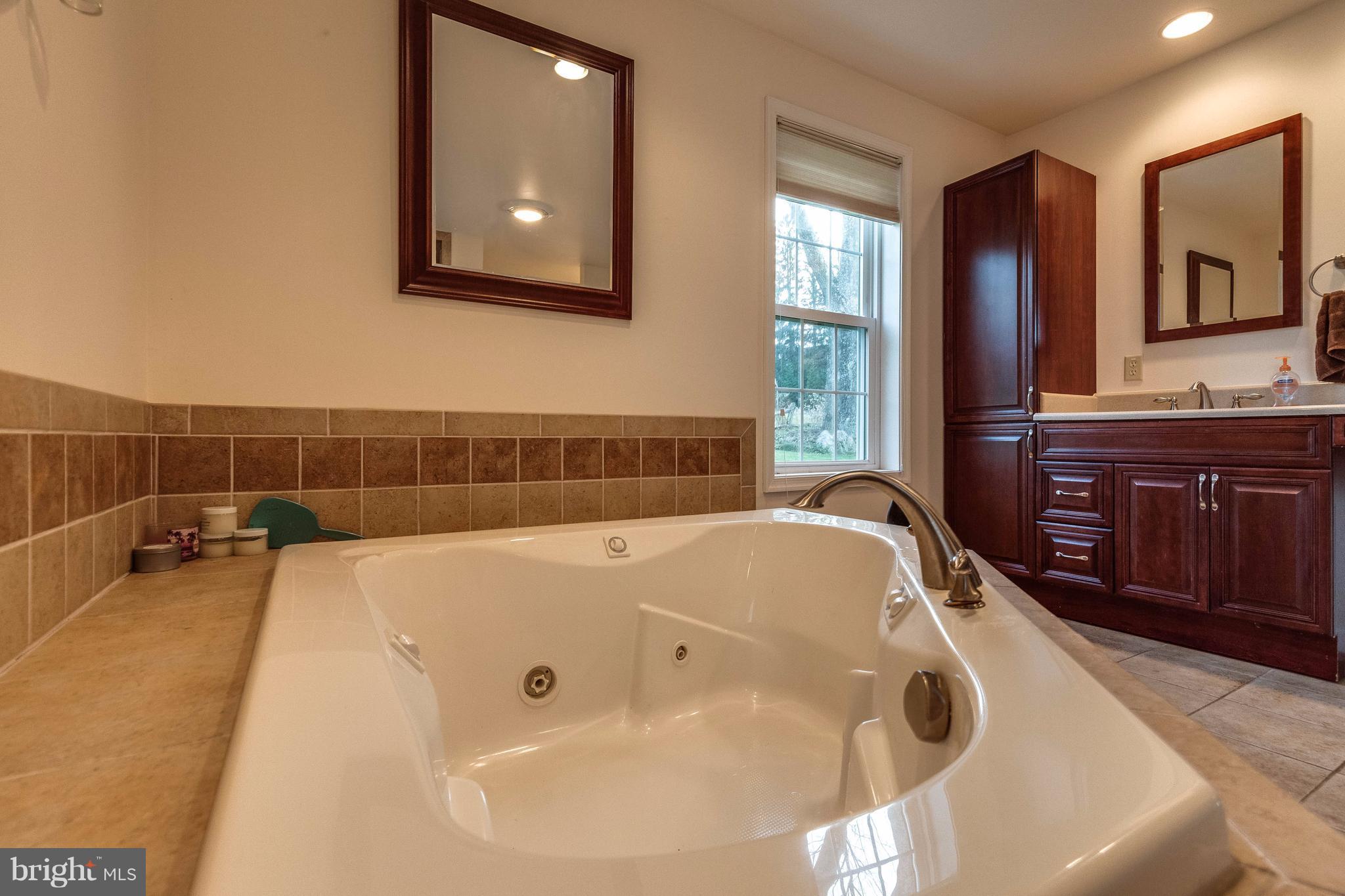 25453 Highfield Road Cascade, MD 21719 - Photo 19 of 30 a spacious bathroom with a tub and window
