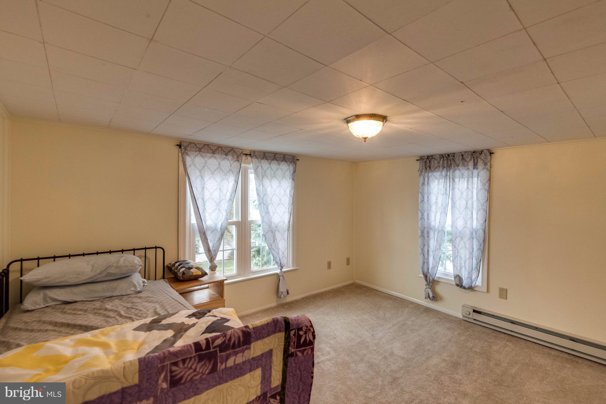25453 Highfield Road Cascade, MD 21719 - Photo 23 of 30 a bedroom with a bed and a window