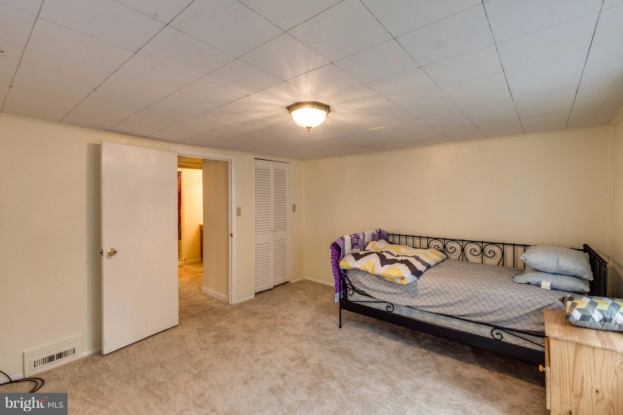 25453 Highfield Road Cascade, MD 21719 - Photo 24 of 30 a bedroom with a bed and a night stand