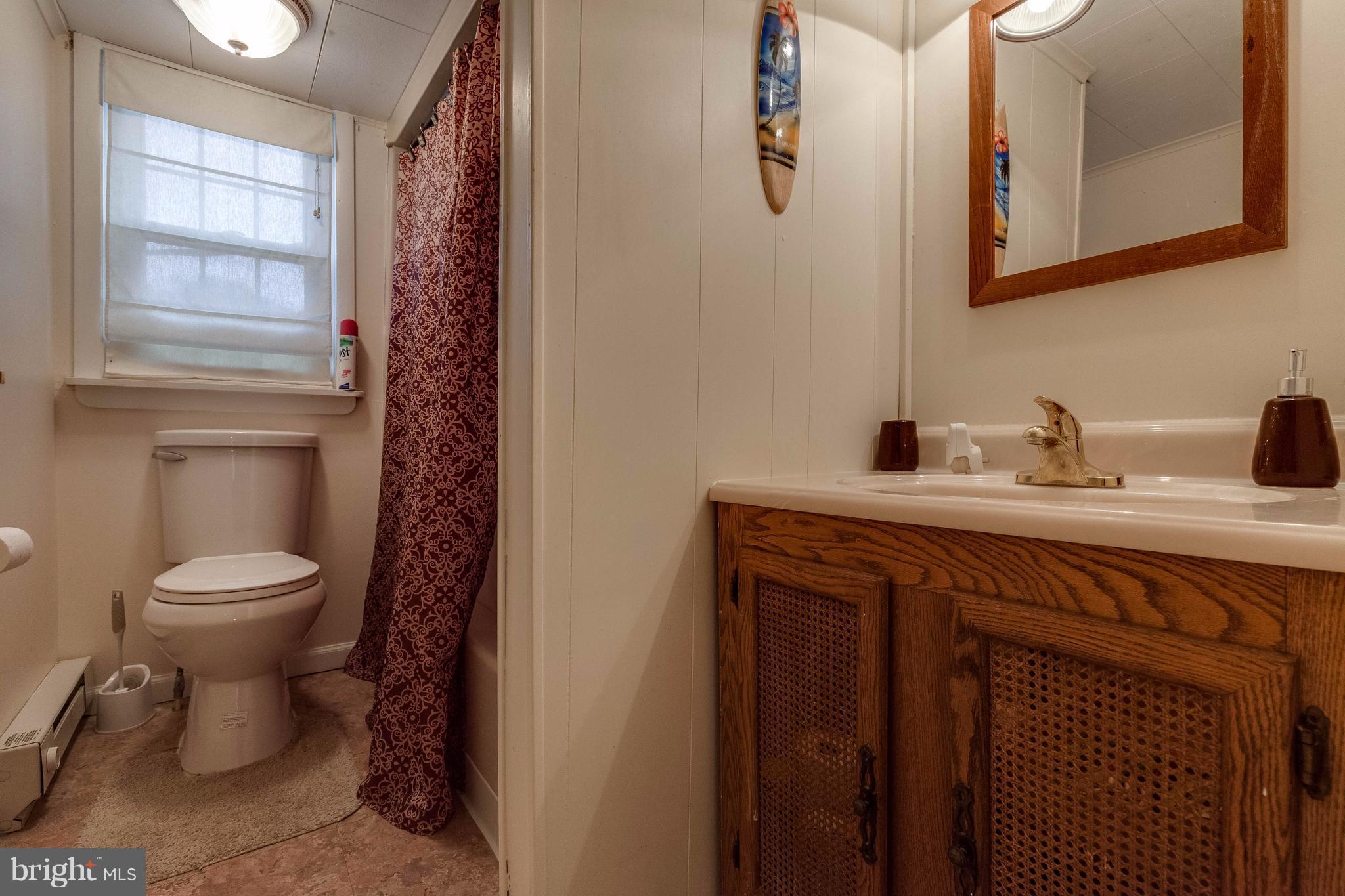 25453 Highfield Road Cascade, MD 21719 - Photo 27 of 30 a bathroom with a toilet sink and mirror
