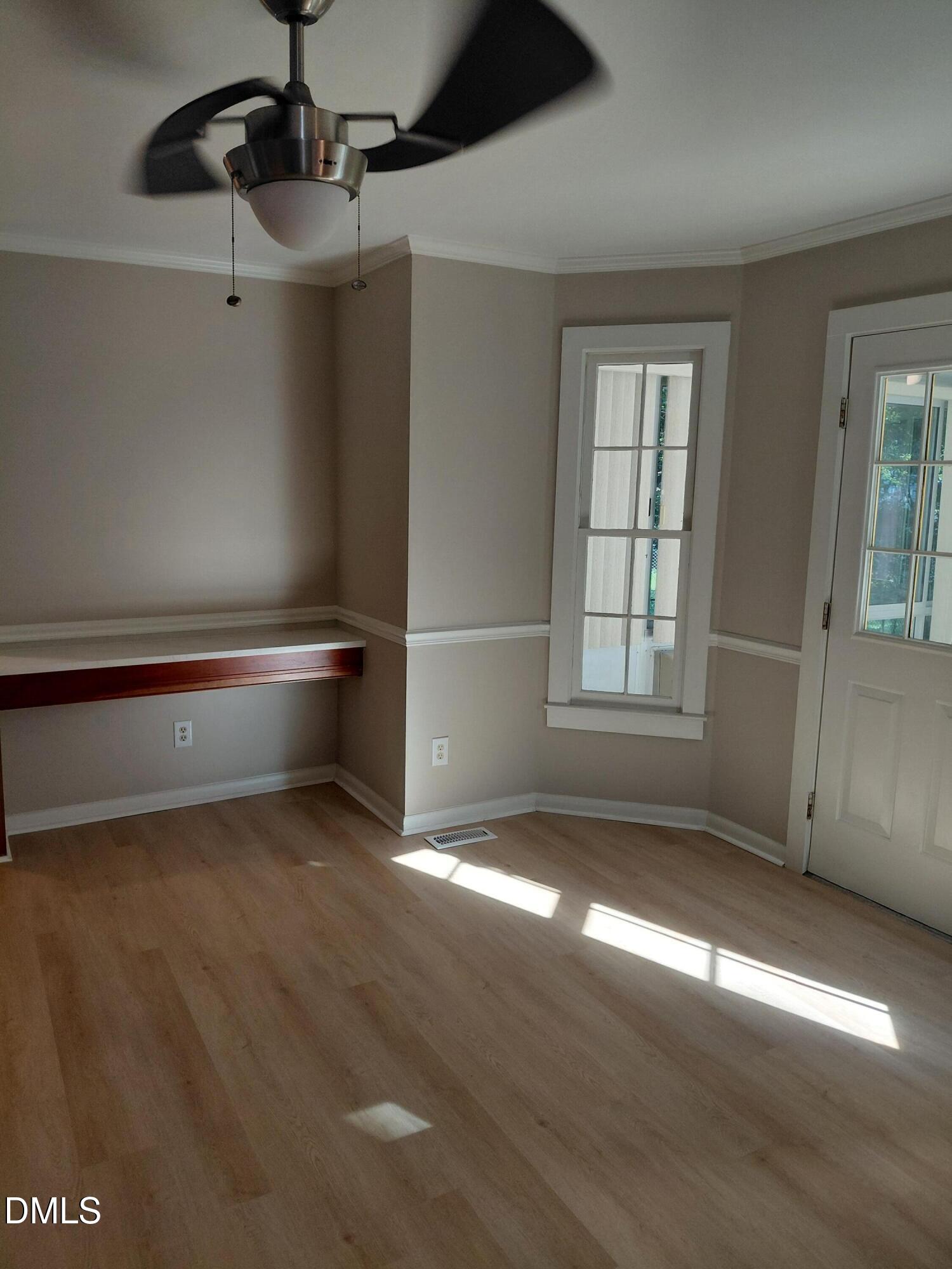 804 Olive Street Apex, NC 27502 - Photo 25 of 60 a view of empty room with wooden floor and fan