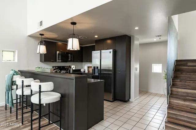 a kitchen with cabinets and stainless steel appliances