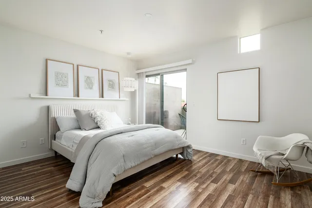 a bedroom with a bed and chair