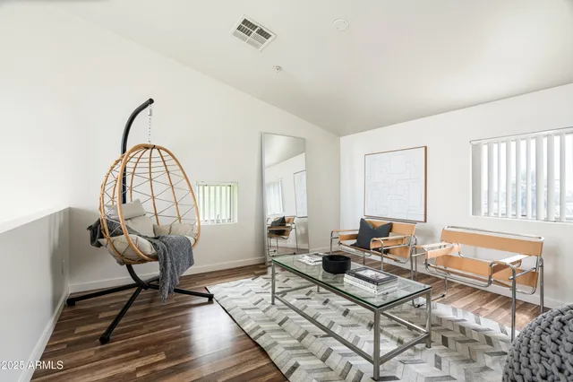 a living room with furniture a rug and a window