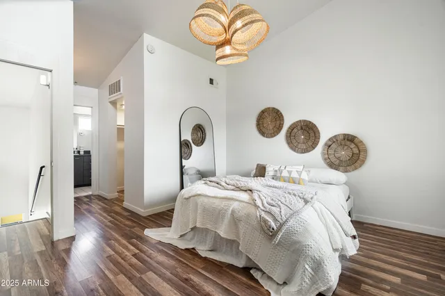 a bedroom with a bed and a chandelier