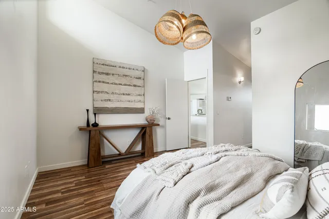 a bedroom with a bed and a chandelier