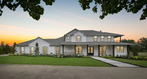 an entryway at a room with wooden floor and windows