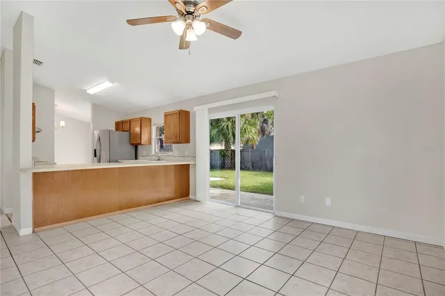 a view of kitchen with refrigerator and window
