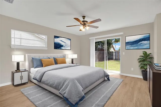 a bedroom with a large bed and a chandelier