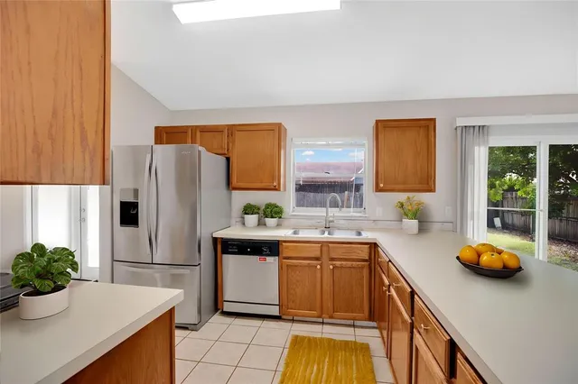 a kitchen with a sink and refrigerator