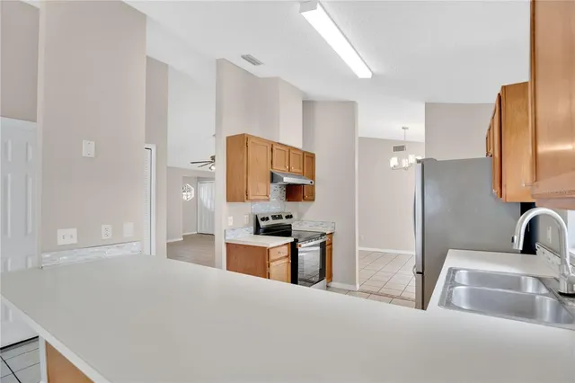 a kitchen with stainless steel appliances a refrigerator stove and sink