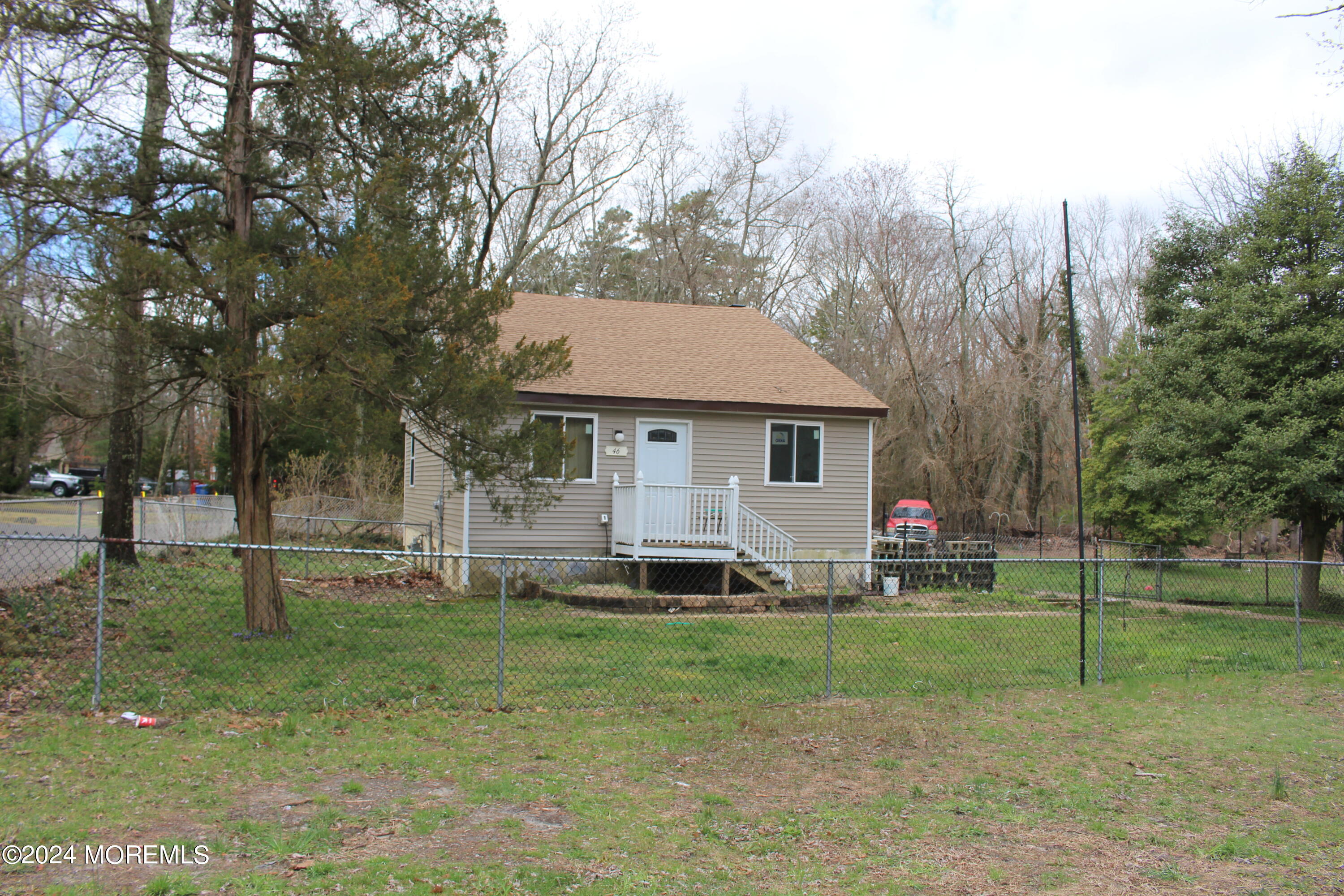46 Toms River Road Jackson, NJ 08527 - Photo 1 of 16 a front view of house with a garden and trees