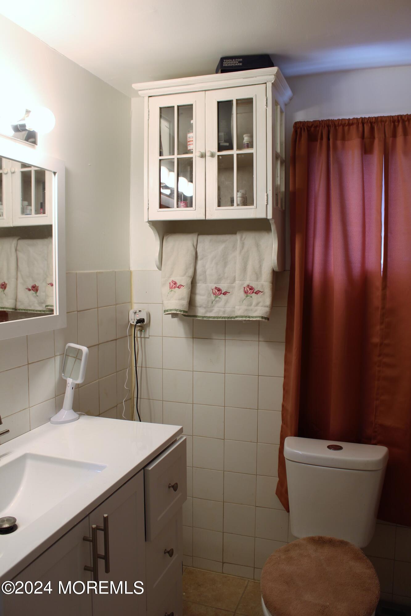 46 Toms River Road Jackson, NJ 08527 - Photo 11 of 16 a bathroom with a sink a toilet and shower