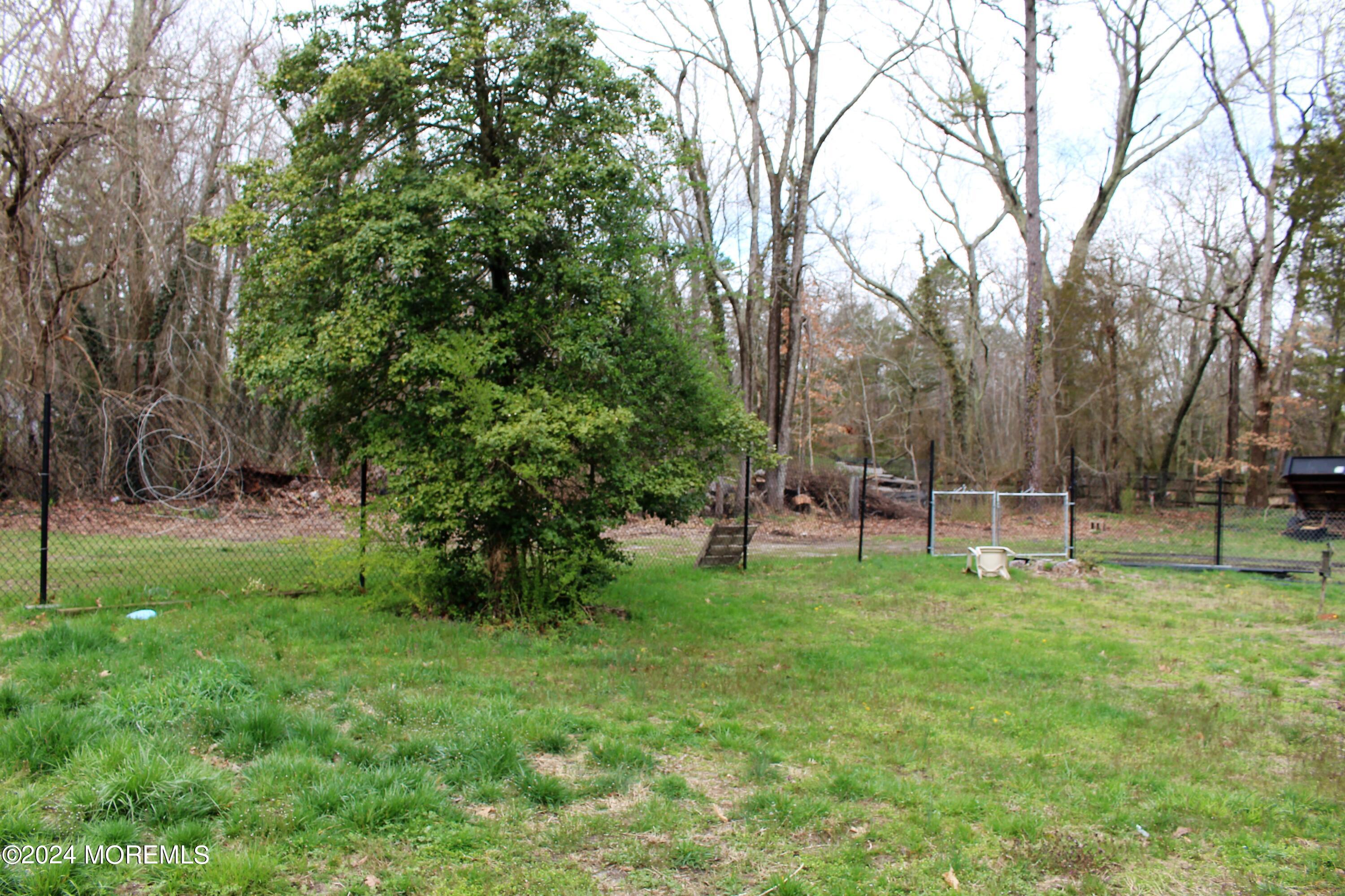 46 Toms River Road Jackson, NJ 08527 - Photo 16 of 16 a view of a backyard with a garden
