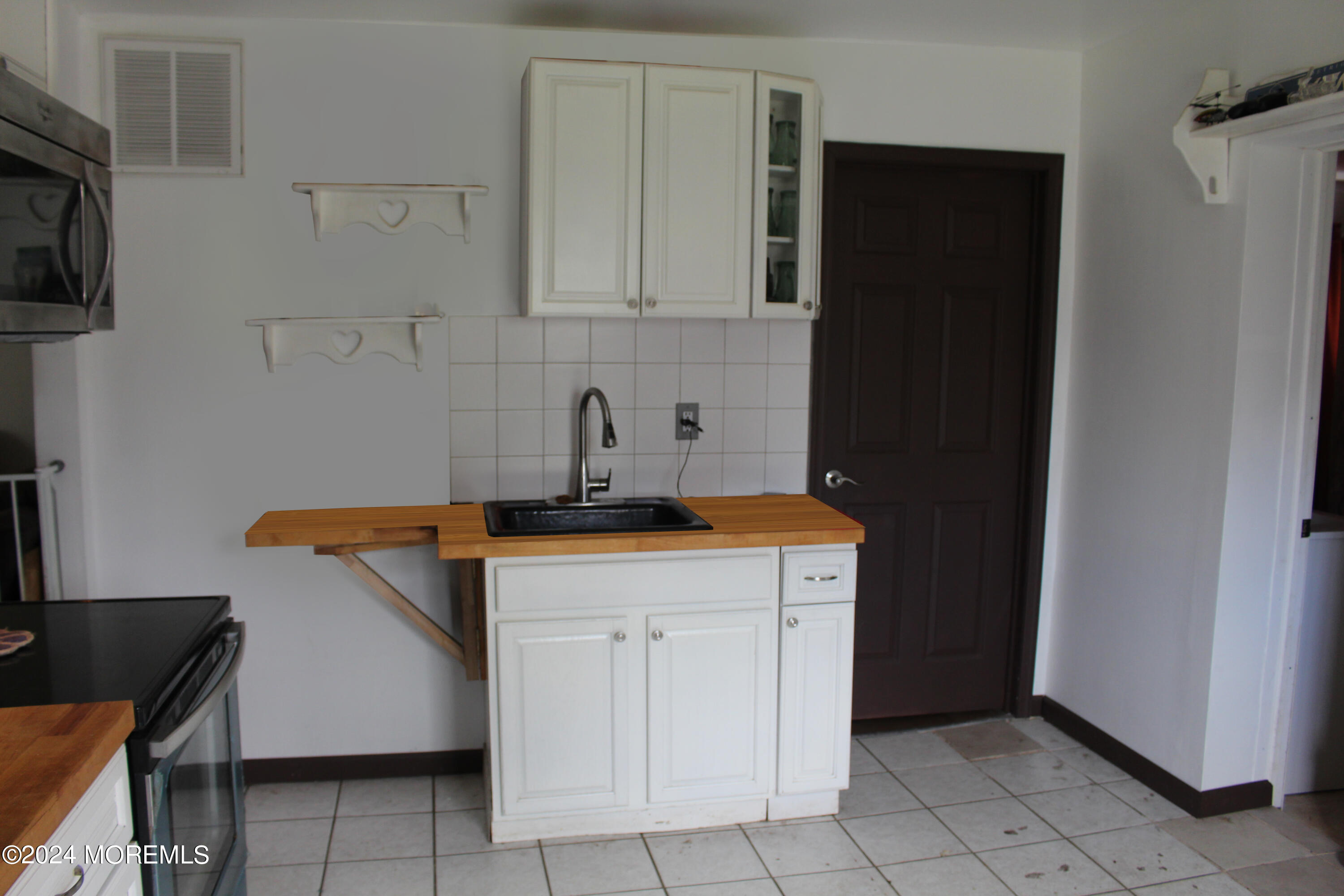 46 Toms River Road Jackson, NJ 08527 - Photo 9 of 16 a kitchen with a sink and cabinets