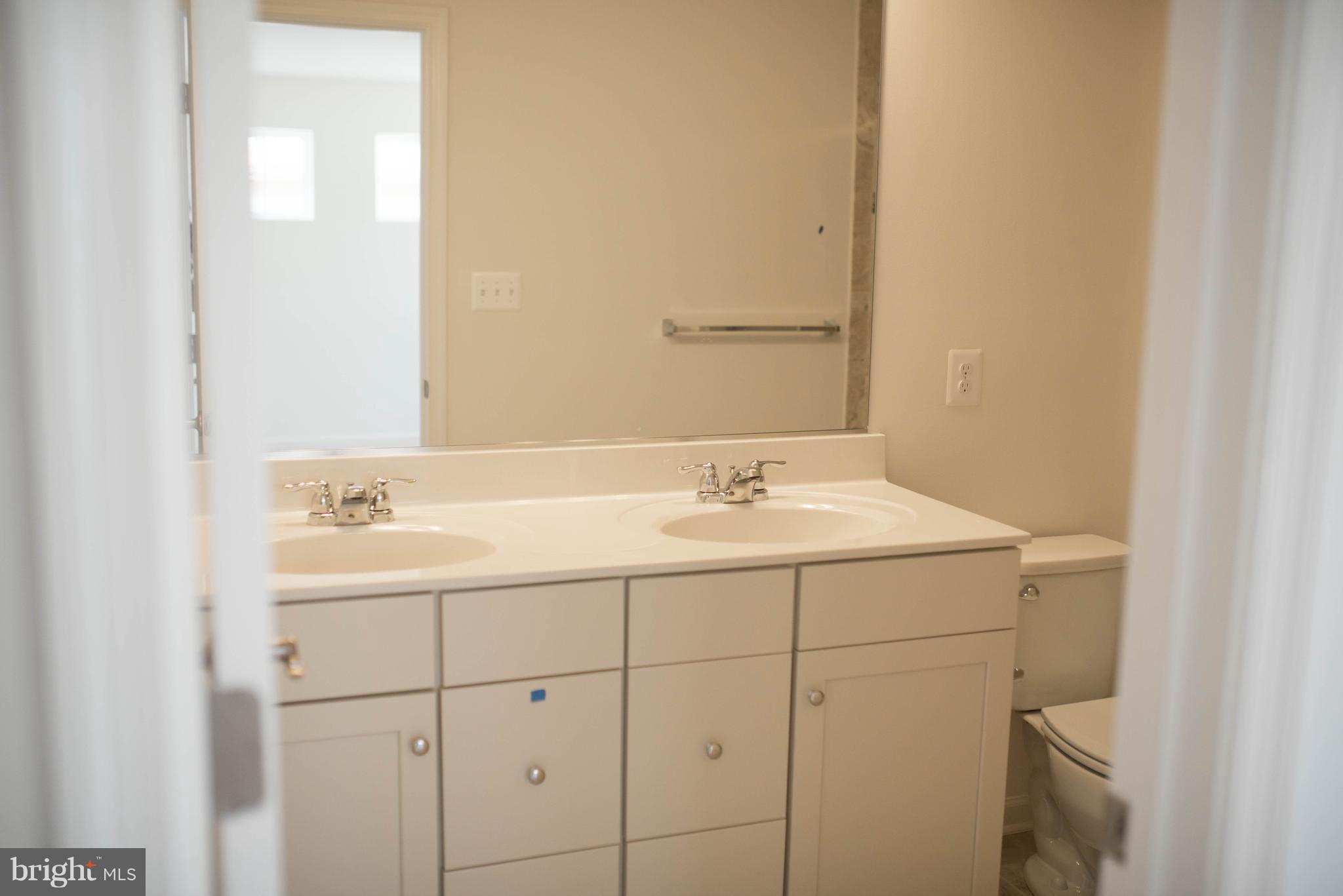 919 Morgan Run Road Baltimore, MD 21220 - Photo 13 of 16 a bathroom with a sink and a mirror