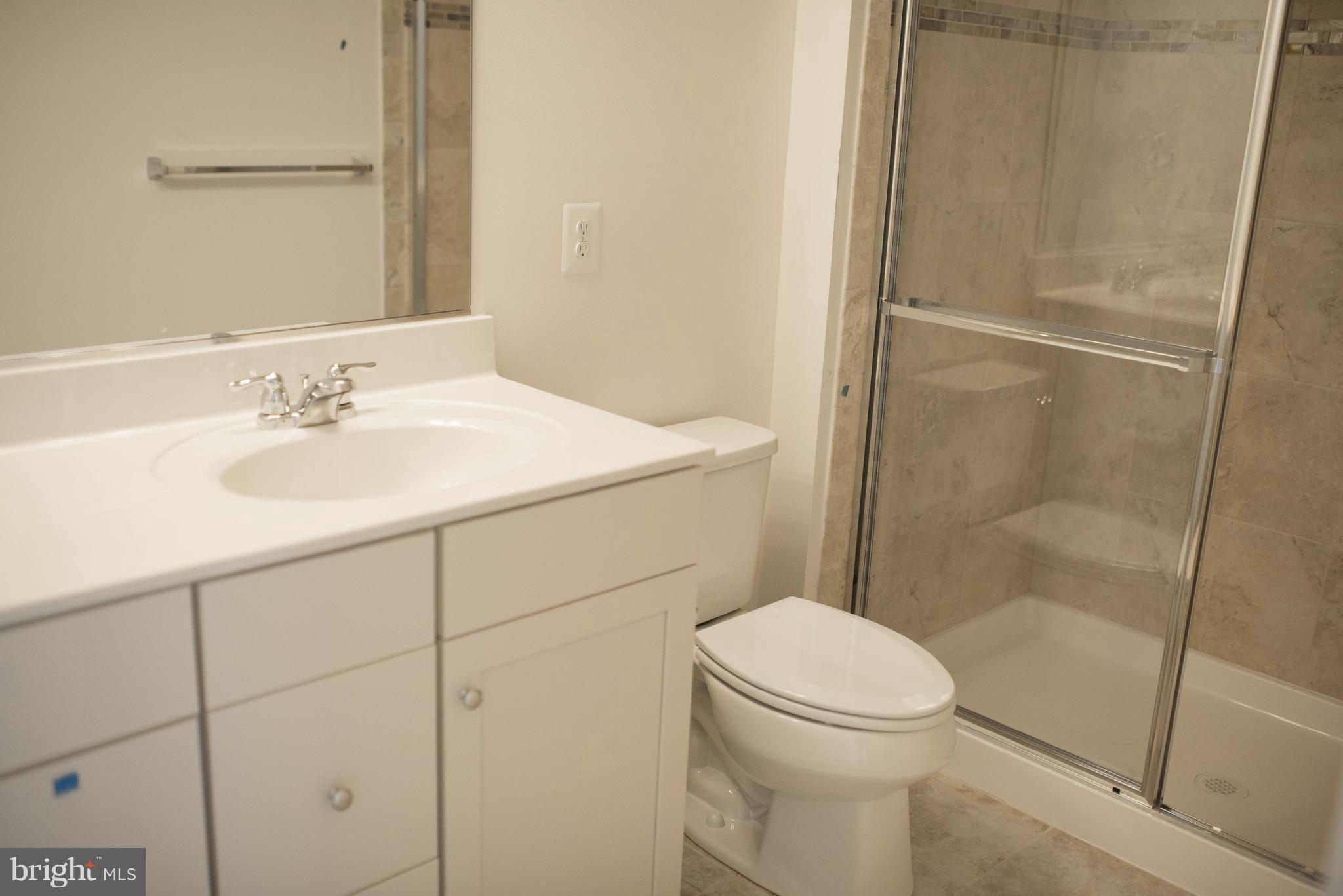 919 Morgan Run Road Baltimore, MD 21220 - Photo 15 of 16 a bathroom with a sink a toilet and shower