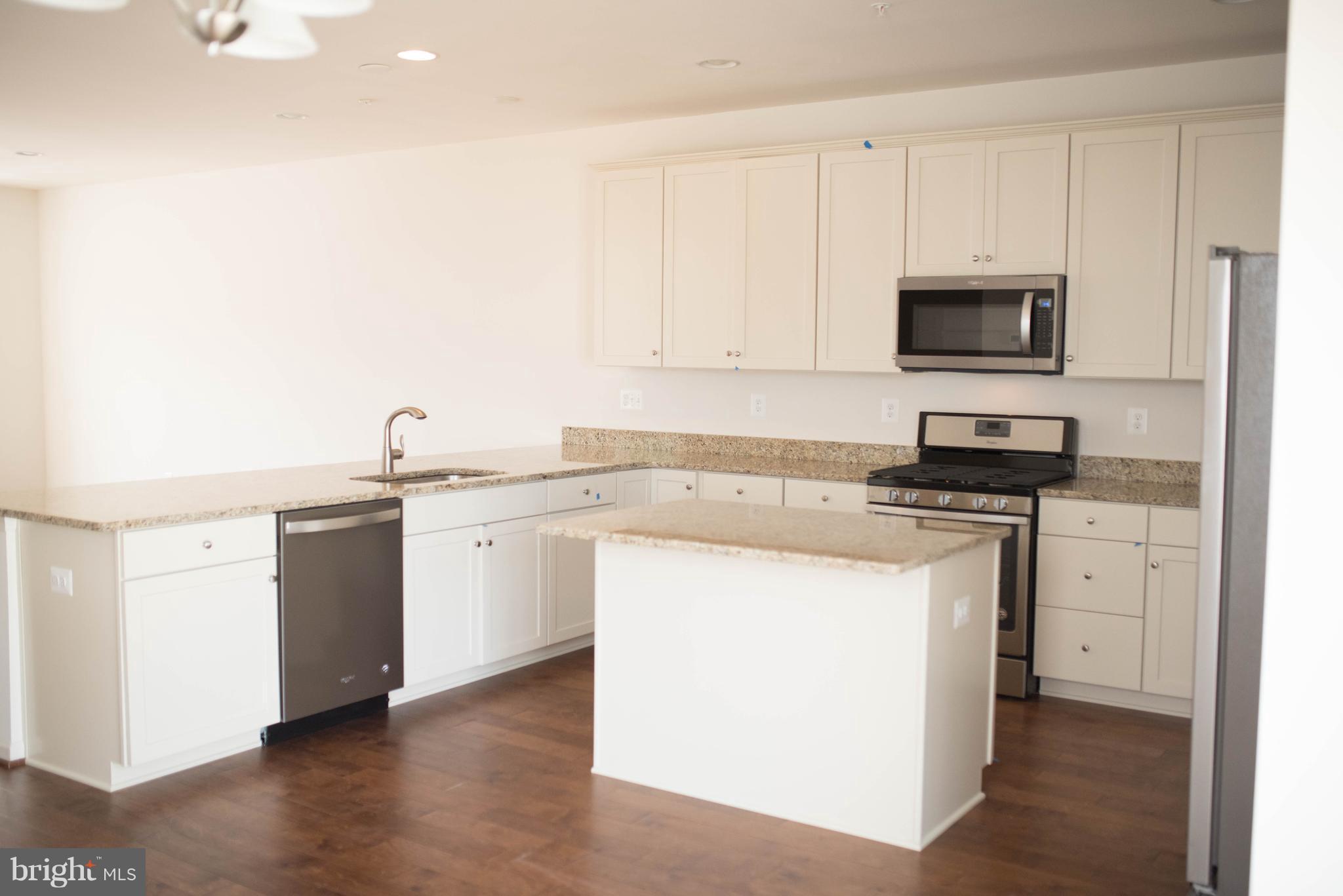 919 Morgan Run Road Baltimore, MD 21220 - Photo 4 of 16 a kitchen with granite countertop white cabinets and stainless steel appliances