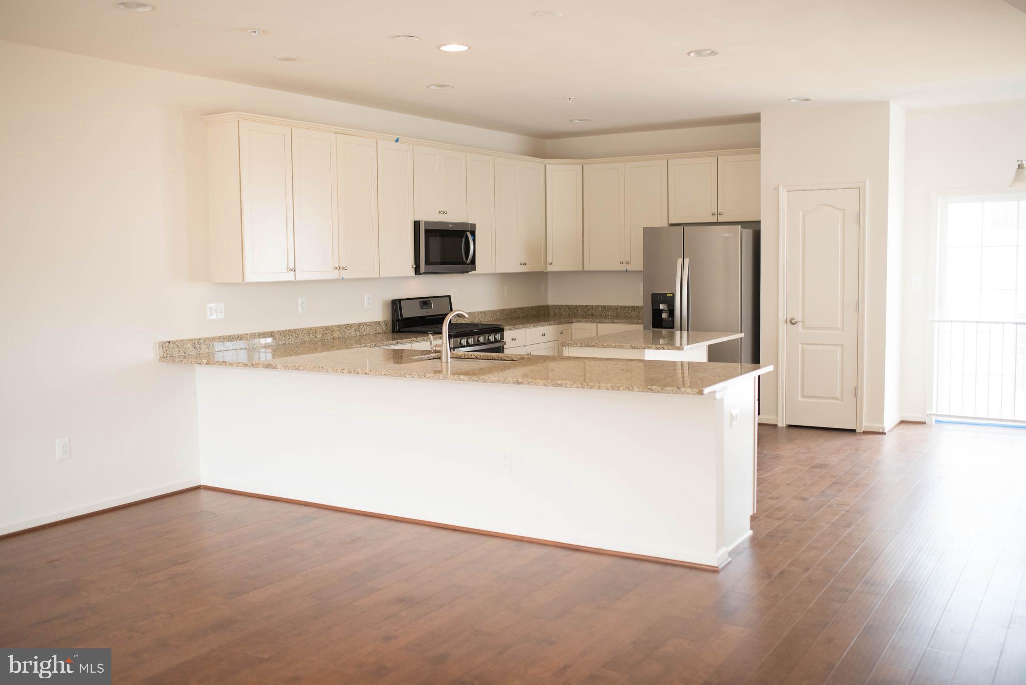 919 Morgan Run Road Baltimore, MD 21220 - Photo 5 of 16 a kitchen with stainless steel appliances a sink a stove a refrigerator and cabinets