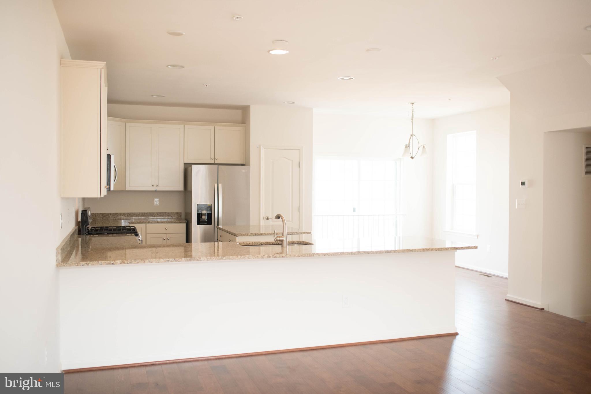 919 Morgan Run Road Baltimore, MD 21220 - Photo 6 of 16 a kitchen with kitchen island a sink a stove and refrigerator