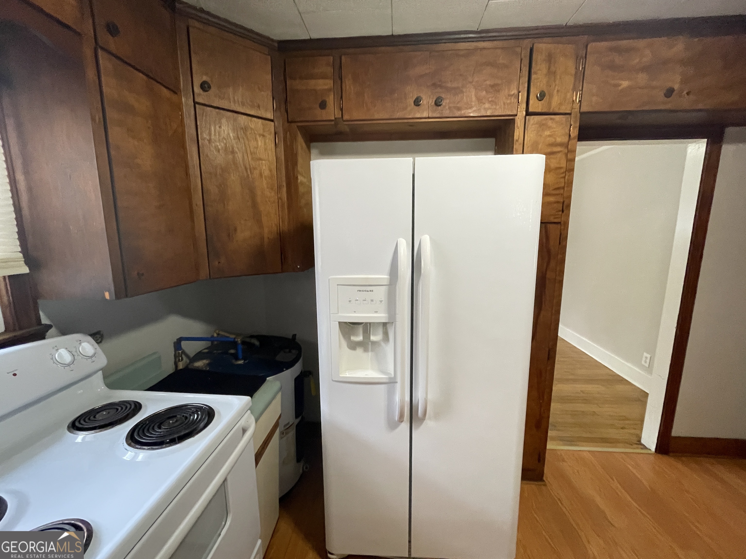 104 4th Street Cochran, GA 31014 - Photo 12 of 41 a kitchen with a refrigerator and a stove