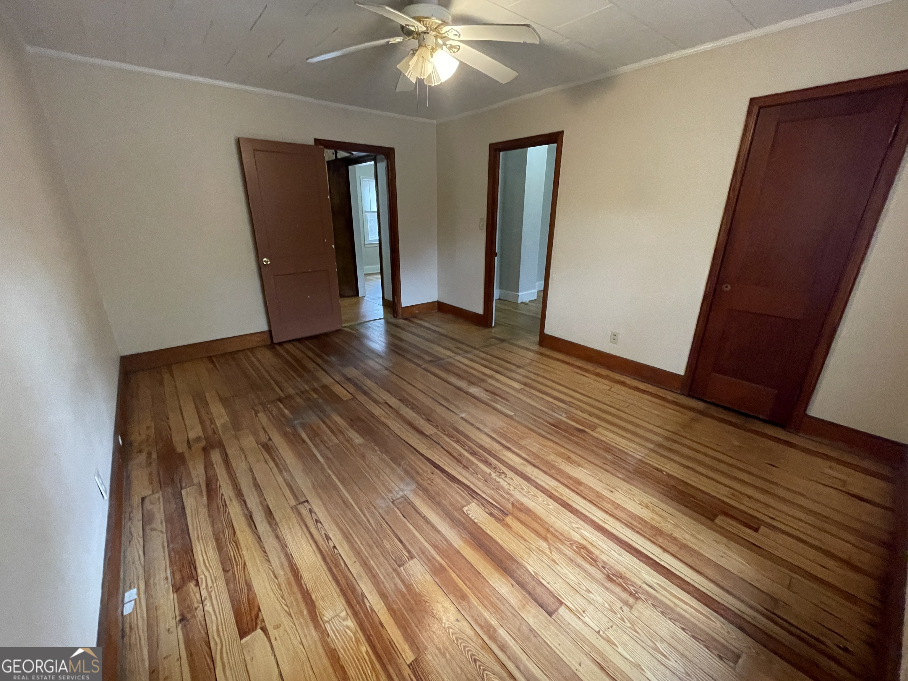 104 4th Street Cochran, GA 31014 - Photo 18 of 41 wooden floor in an empty room with a window