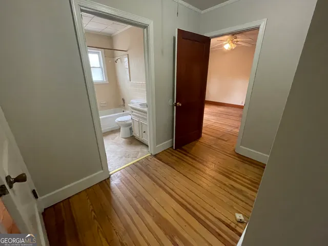 a view of a room with wooden floor and a window