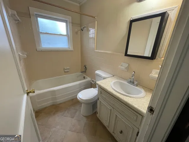 a bathroom with a sink a toilet and mirror