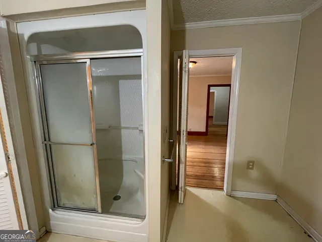 a bathroom with a glass shower door
