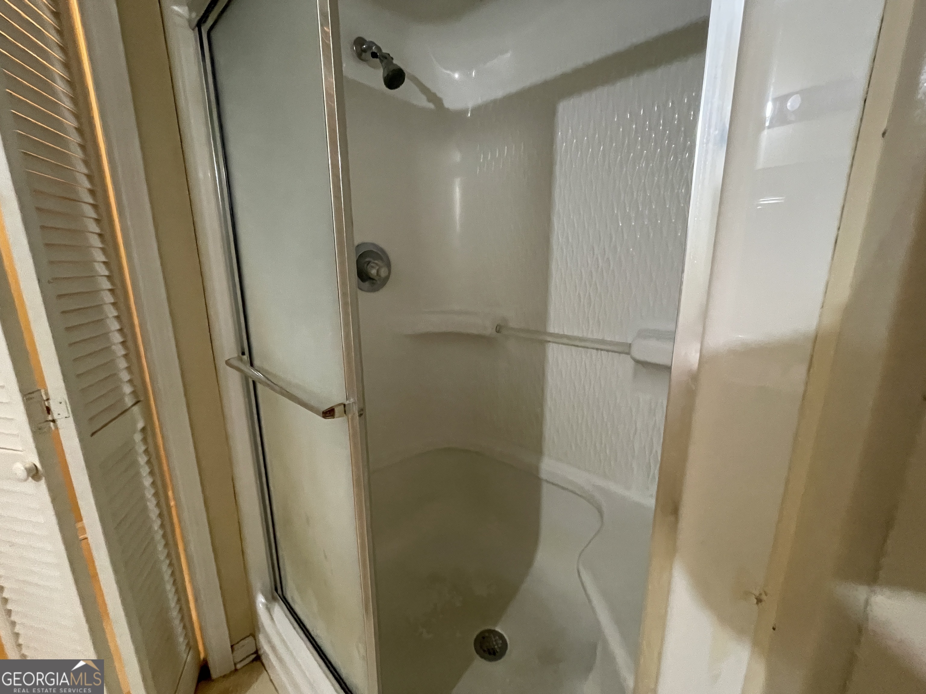 104 4th Street Cochran, GA 31014 - Photo 29 of 41 a bathroom with a glass door shower