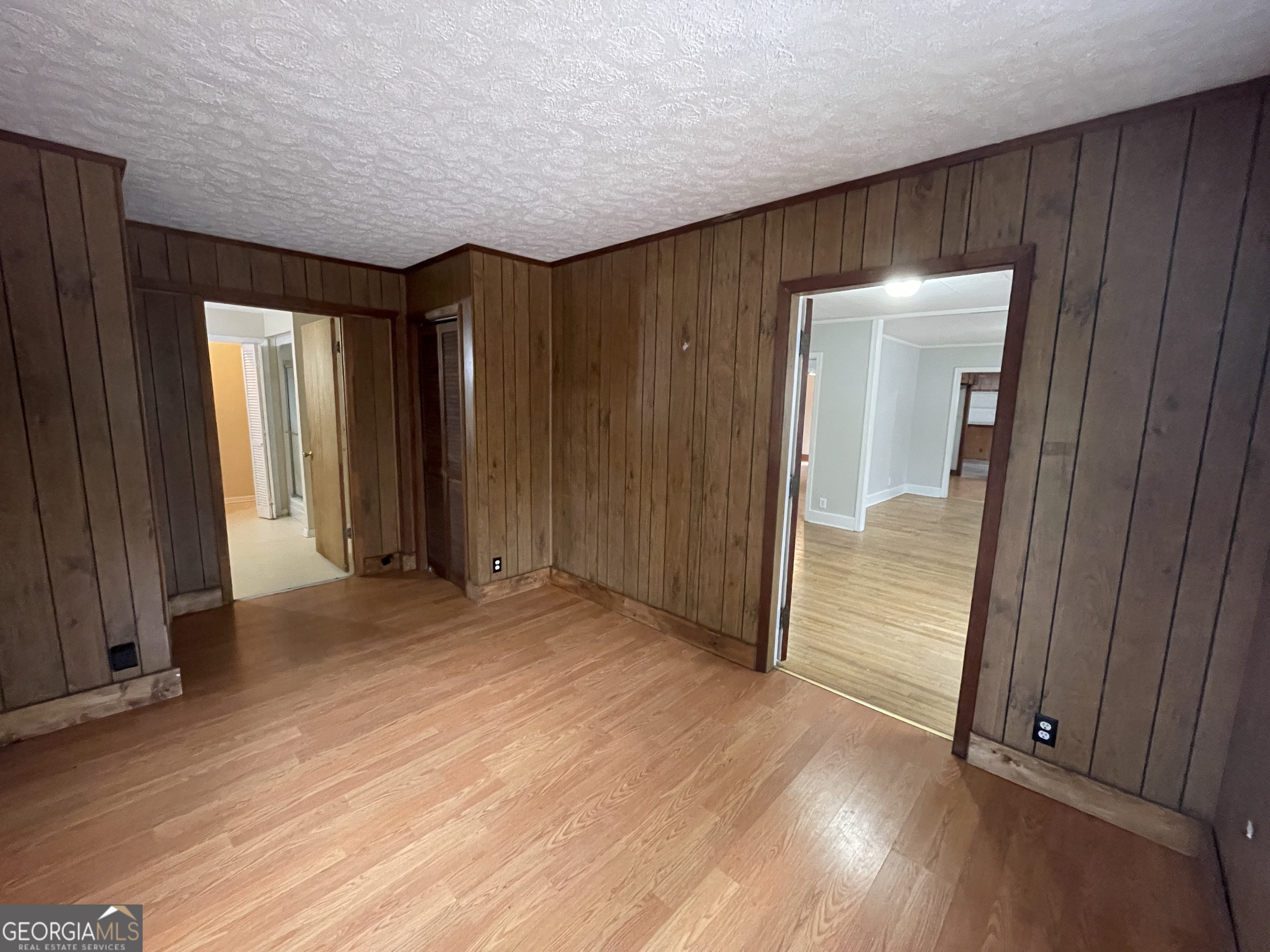 104 4th Street Cochran, GA 31014 - Photo 34 of 41 an empty room with wooden floor and windows