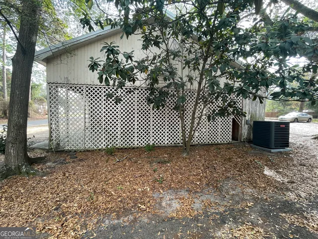 a view of a house with a tree in the background