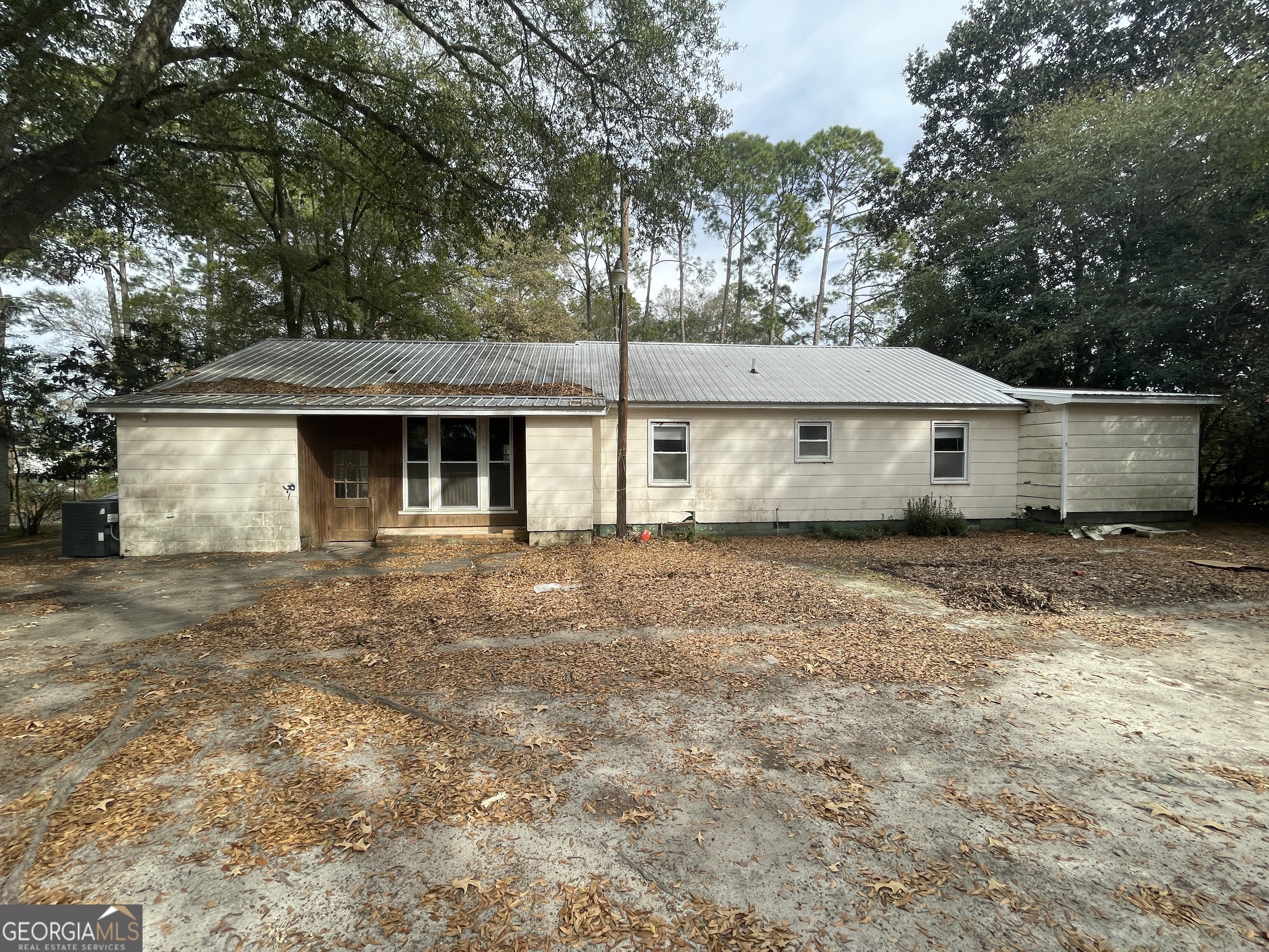 104 4th Street Cochran, GA 31014 - Photo 6 of 41 a front view of a house with a garden