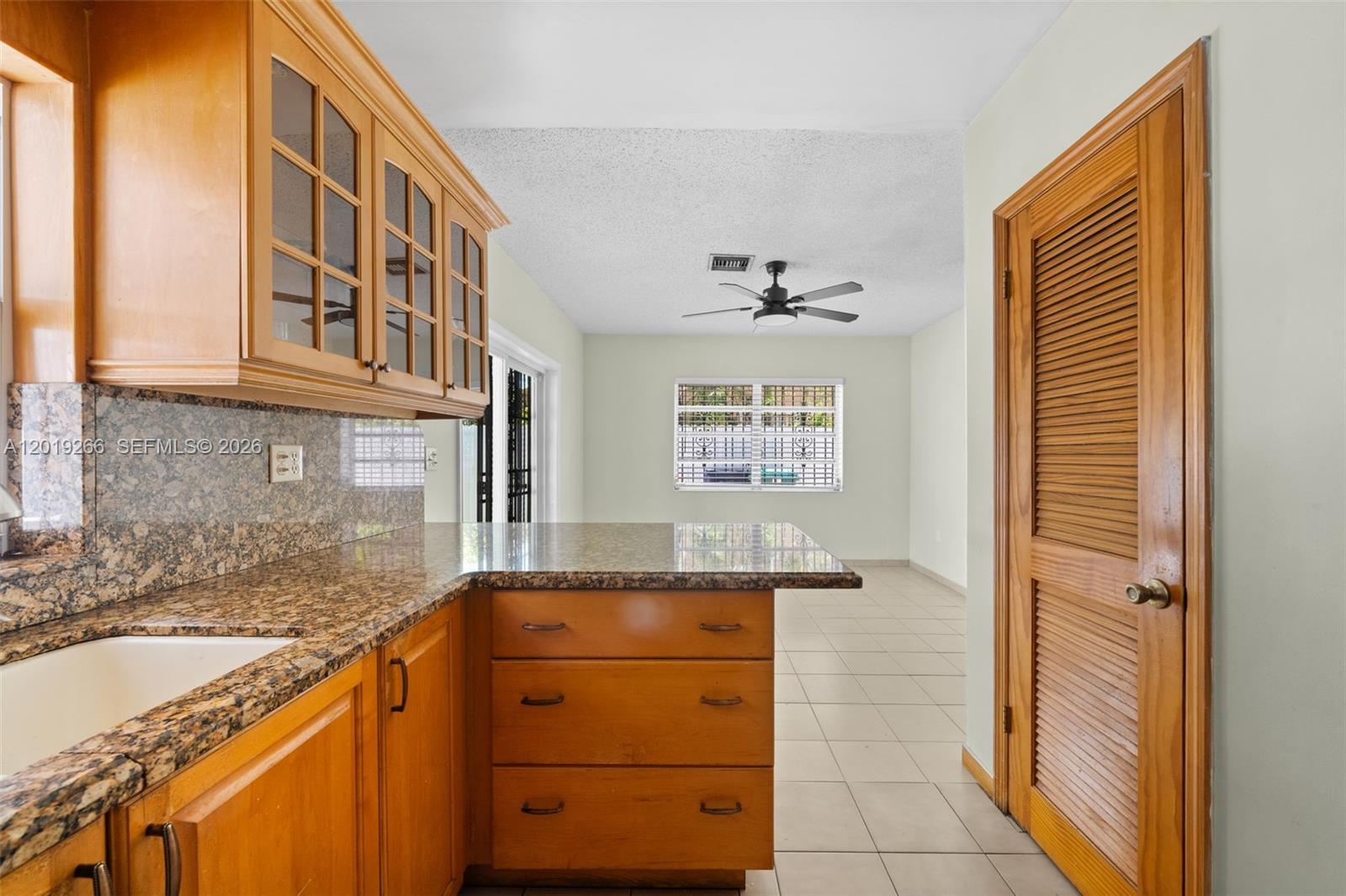 13 Southwest 97th Place Miami, FL 33174 - Photo 11 of 29 a view of a kitchen cabinets a sink and a window