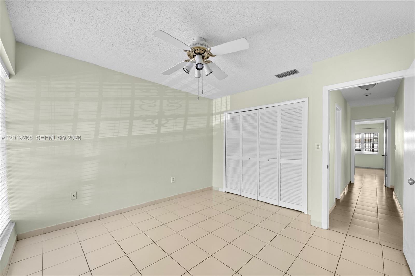 13 Southwest 97th Place Miami, FL 33174 - Photo 16 of 29 a view of a livingroom with a chandelier fan and windows
