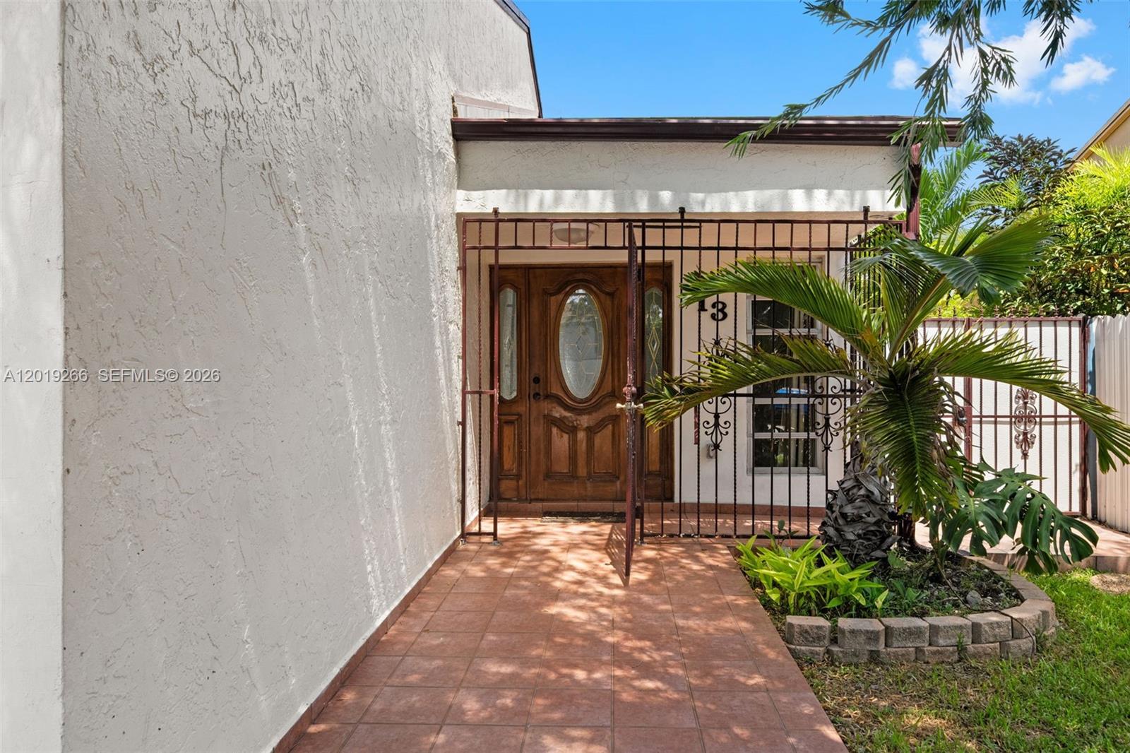 13 Southwest 97th Place Miami, FL 33174 - Photo 2 of 29 a front view of a house with garden