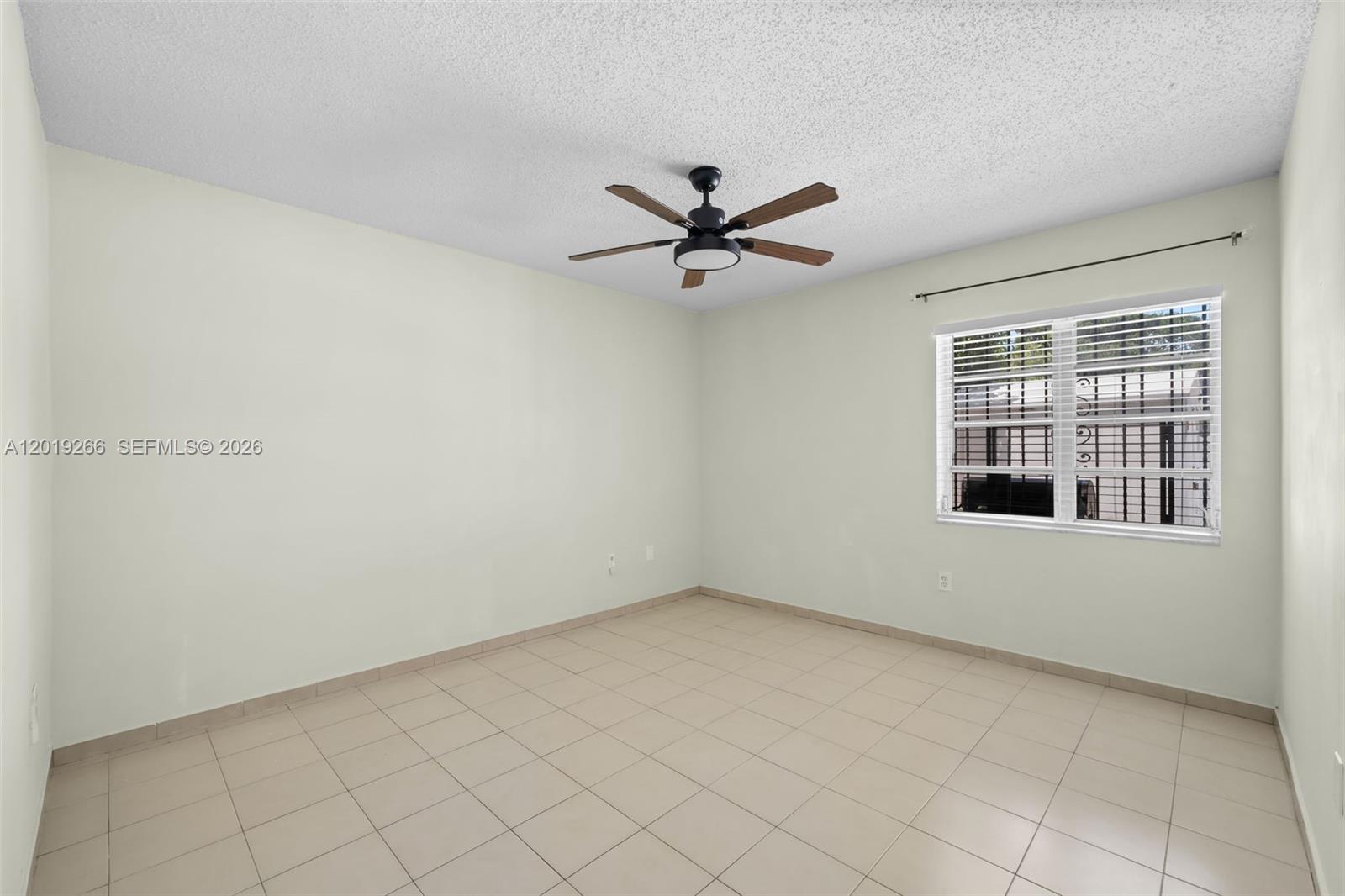 13 Southwest 97th Place Miami, FL 33174 - Photo 22 of 29 an empty room with windows and fan