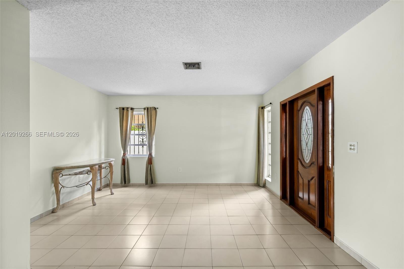 13 Southwest 97th Place Miami, FL 33174 - Photo 3 of 29 a view of an empty room with window and bathroom