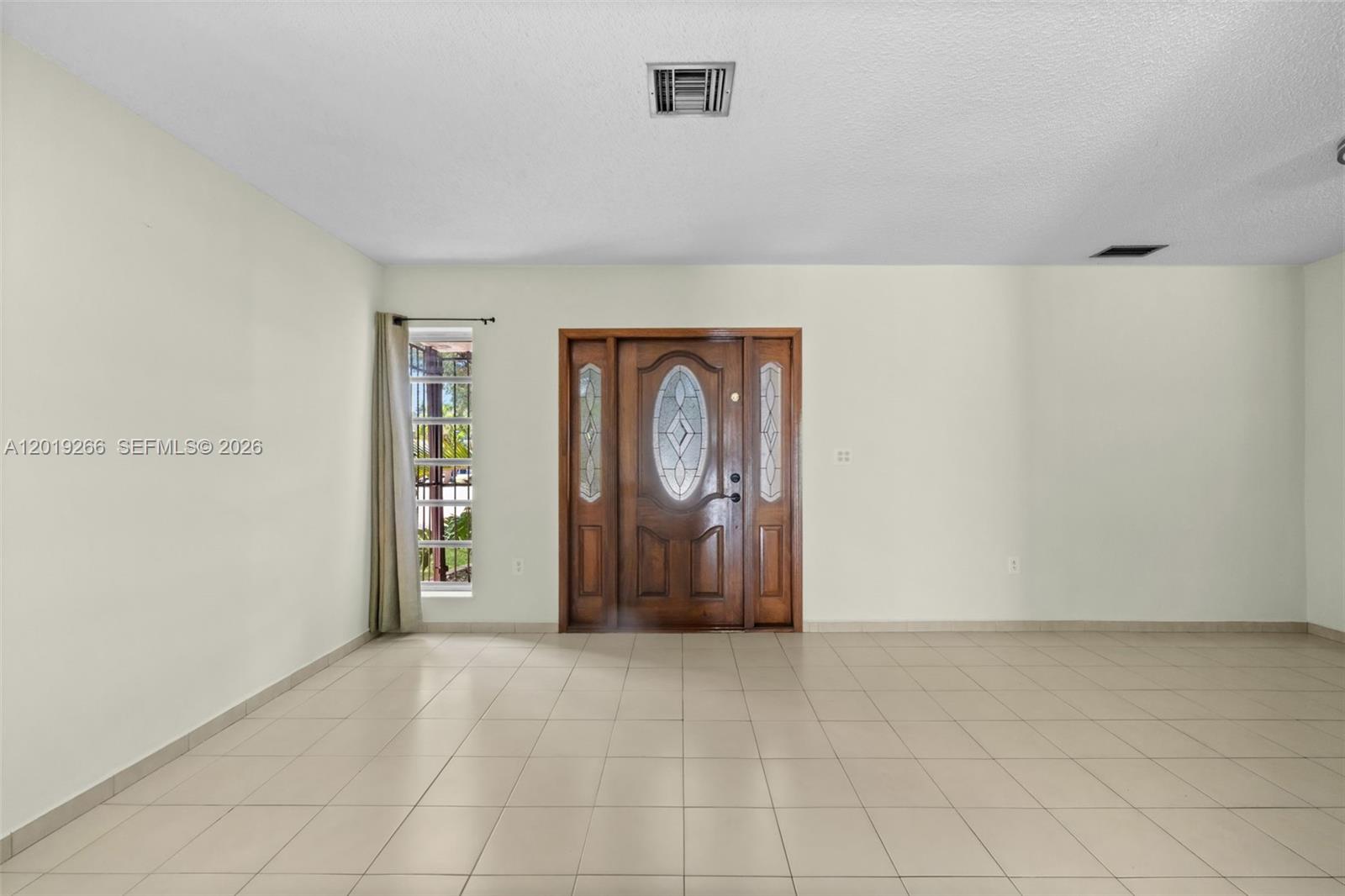 13 Southwest 97th Place Miami, FL 33174 - Photo 4 of 29 an empty room with windows